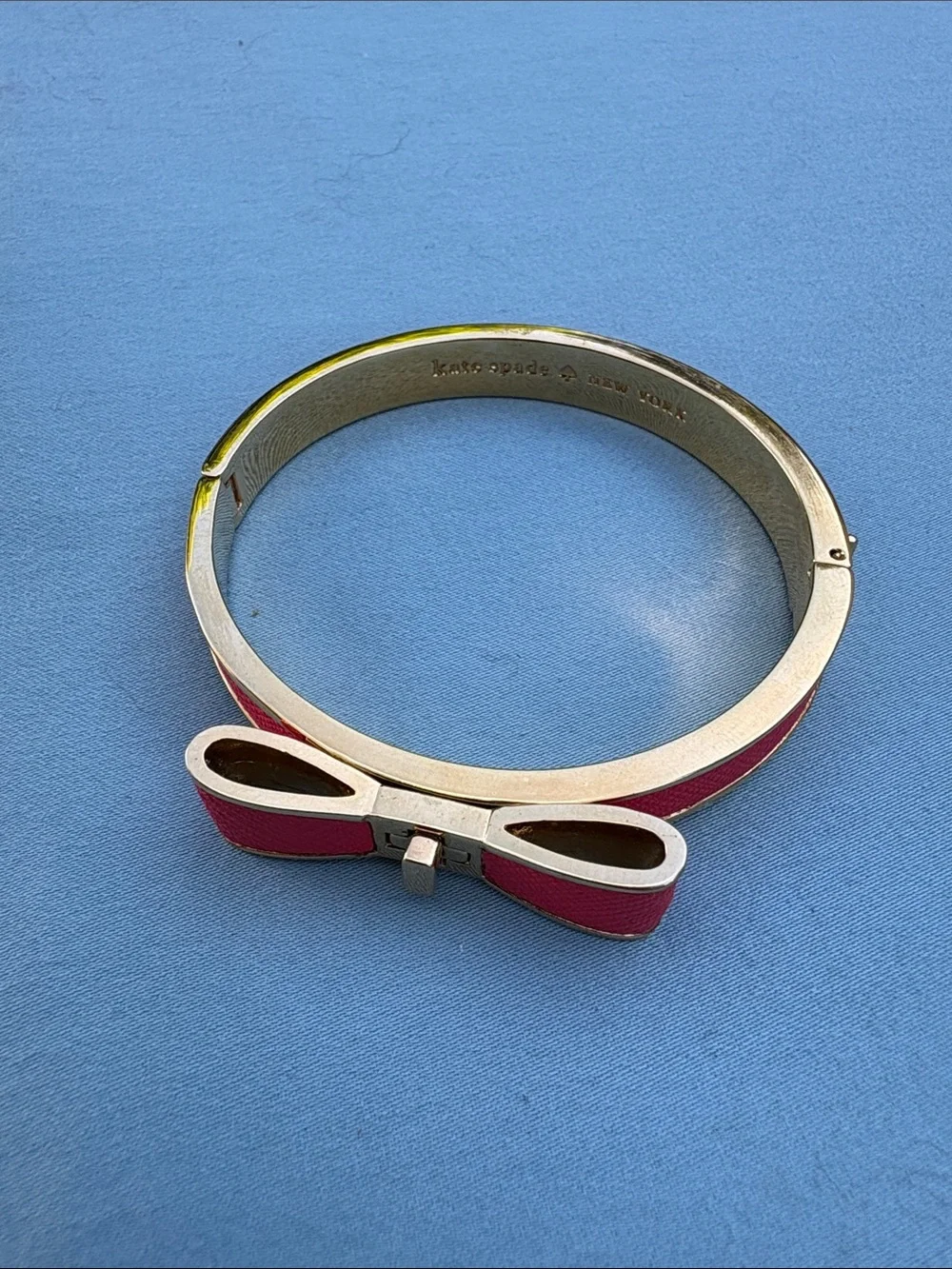 kate spade gold-tone bangle with pink enamel bow